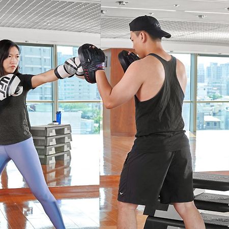 Windsor Hotel Taichung Eksteriør billede A woman and a man training in a gym